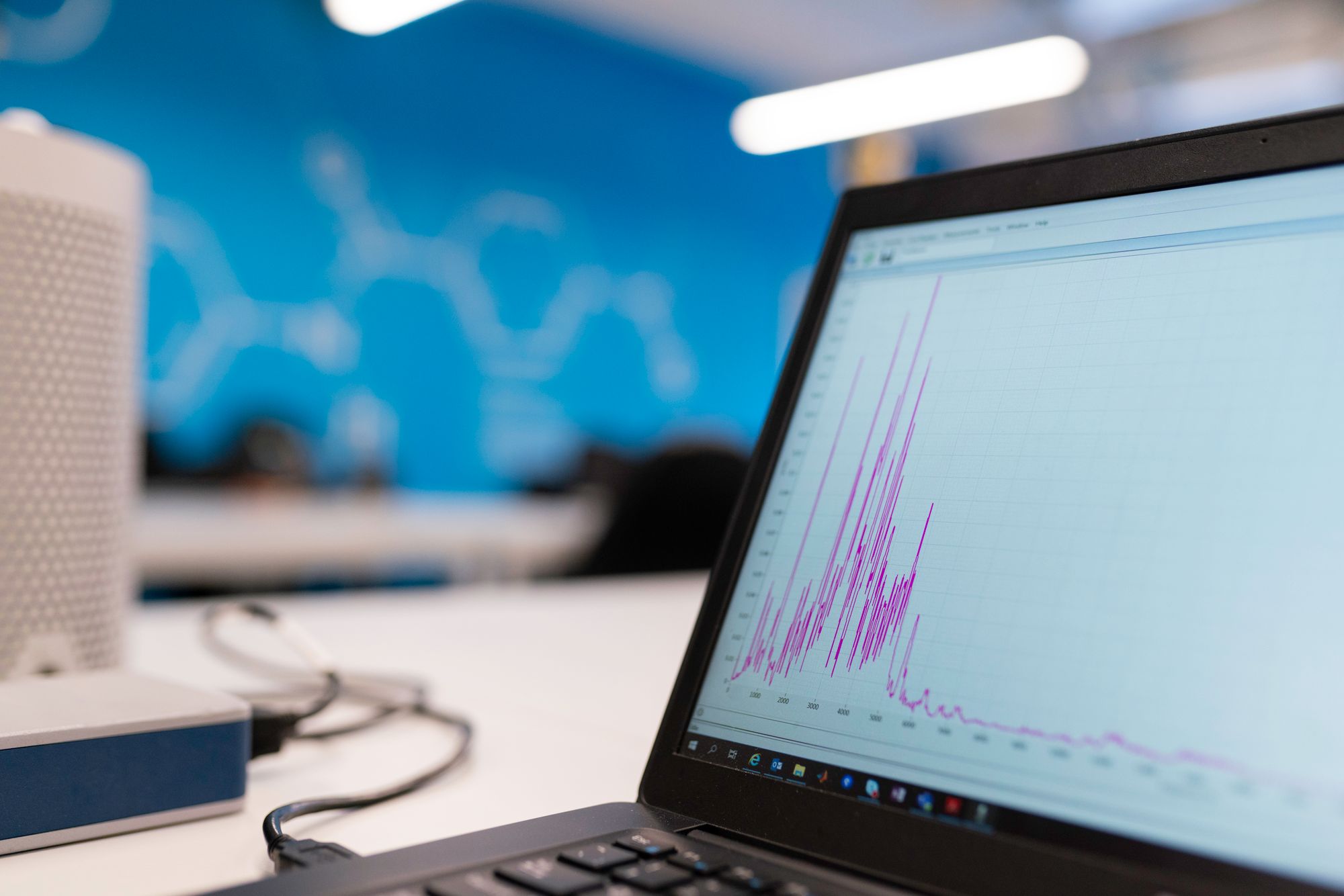 Laptop displaying a time-series analysis graph in an engineering workspace.