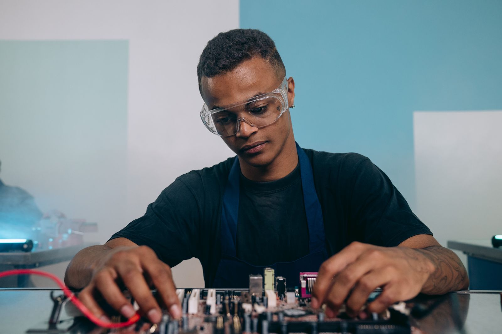 Engineer inspecting precision laboratory hardware at a technical workbench.