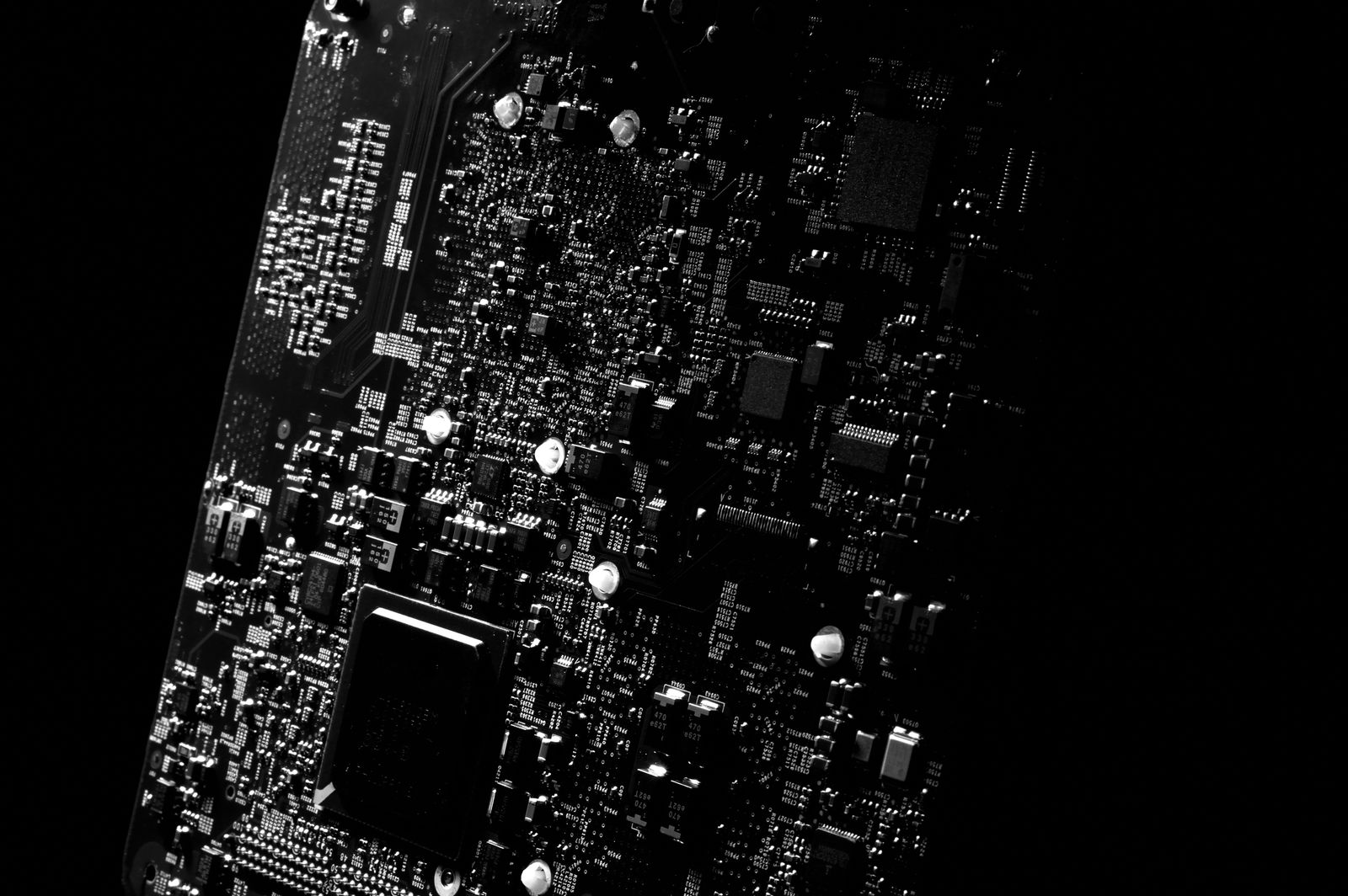 Monochrome close-up of components on a printed circuit board.