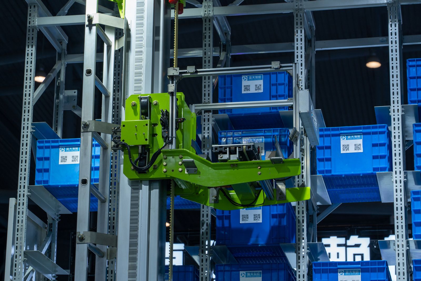 Automated storage mechanism moving blue crates inside a high-density warehouse.
